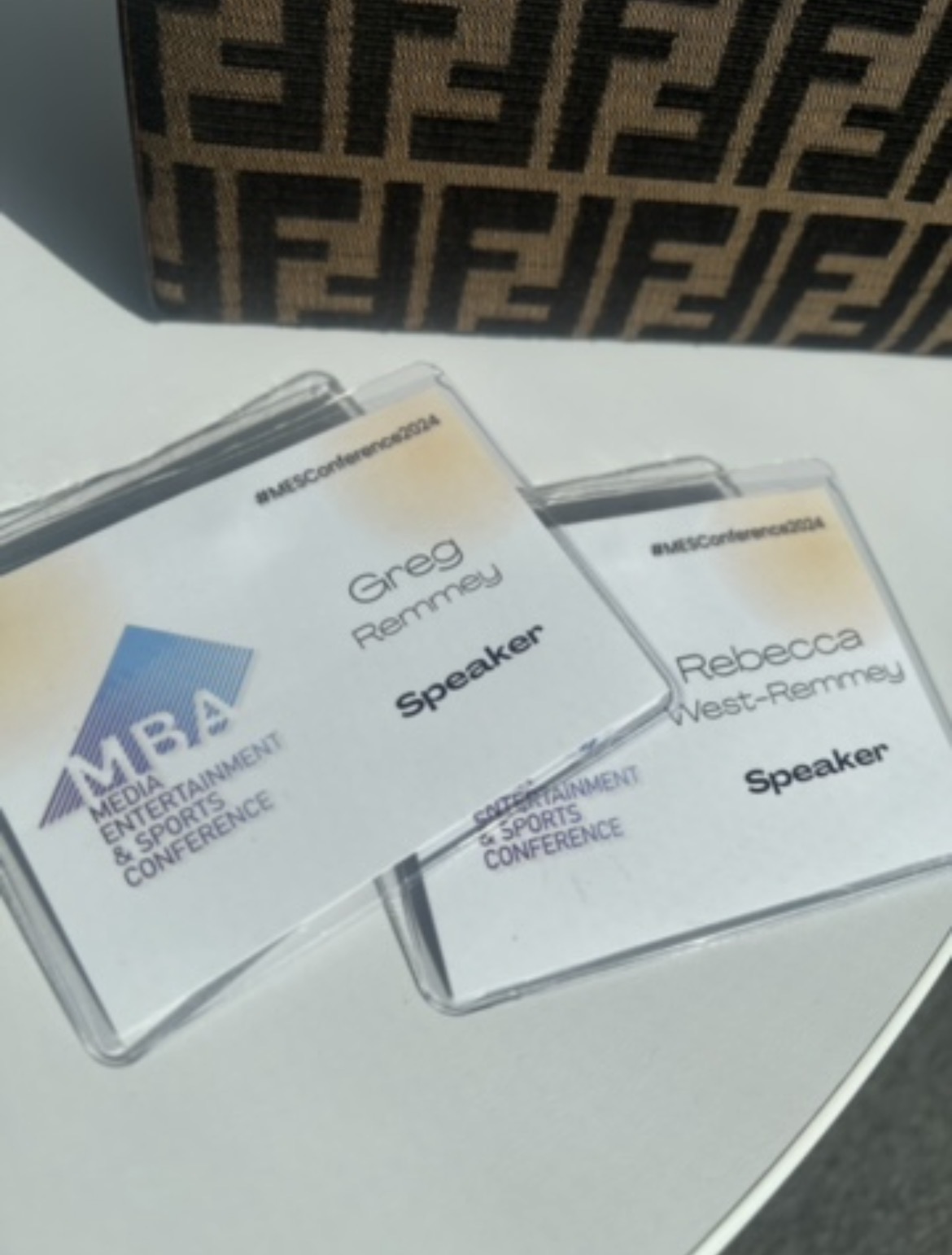 Greg Remmey and Rebecca West-Remmey speaker badges