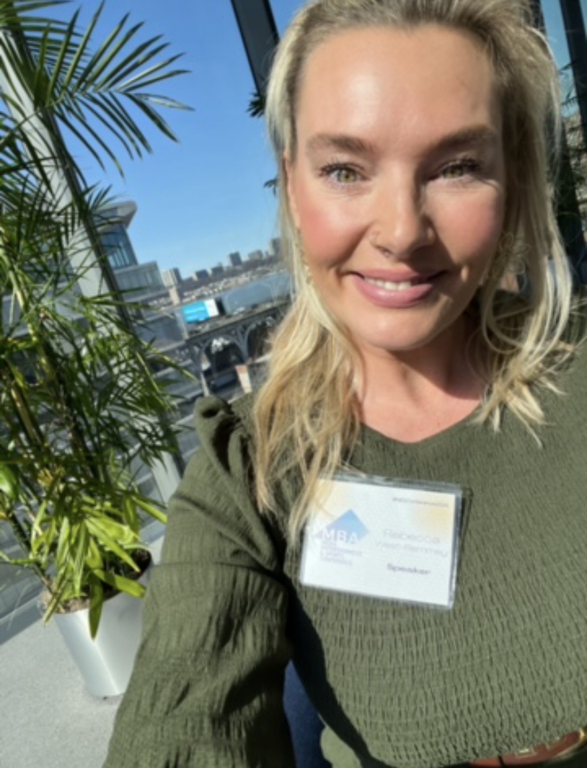 Rebecca West-Remmey with speaker badge at the conference
